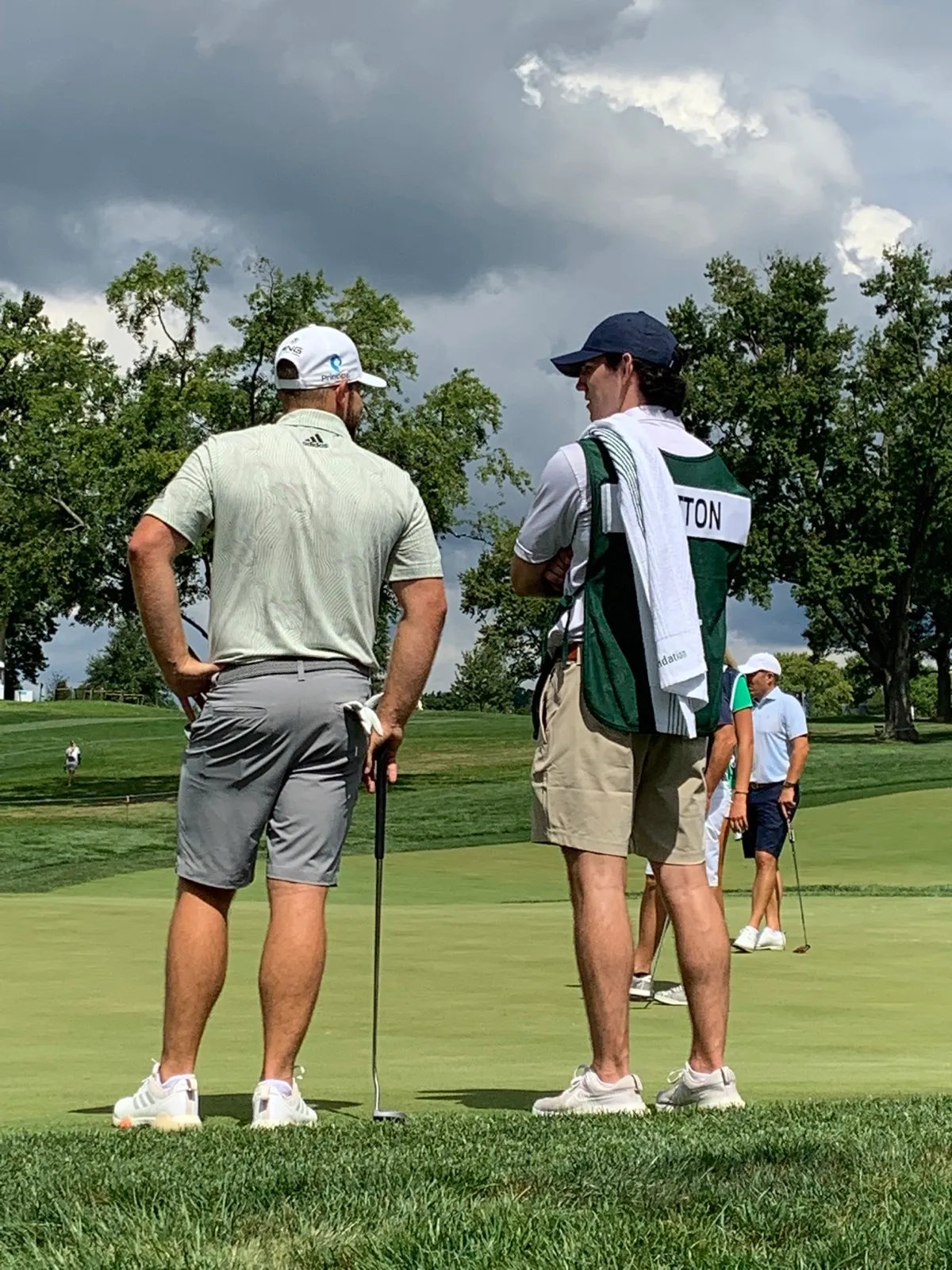 Tyrrell Hatton practicing with caddie alongside on the range