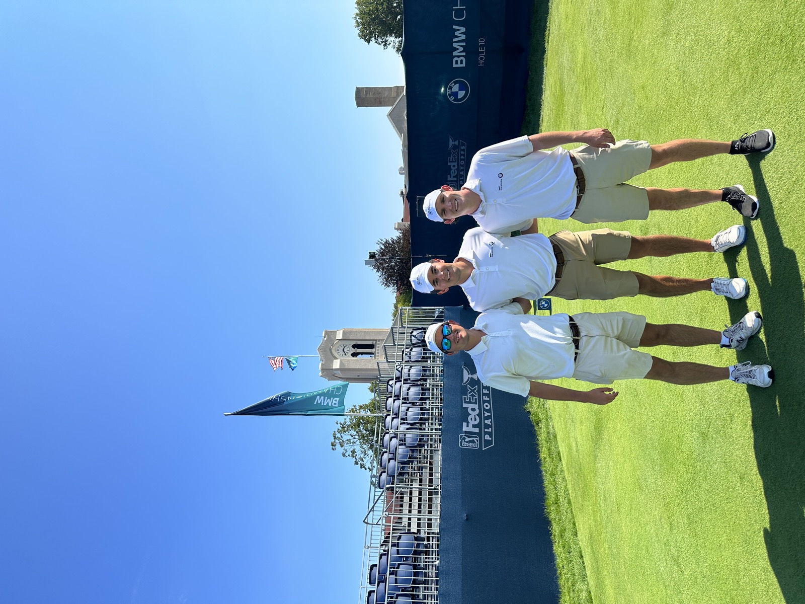 Evans Scholar caddies at the 10th hole with FedEx Cup Playoffs signage