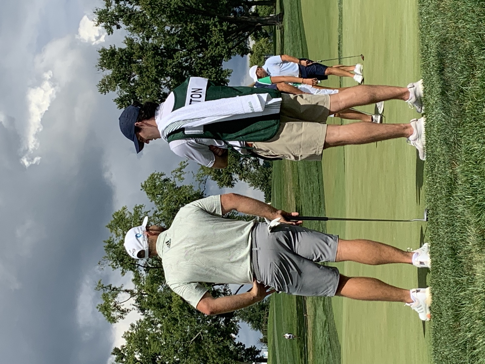 Tyrrell Hatton practicing with caddie alongside on the range