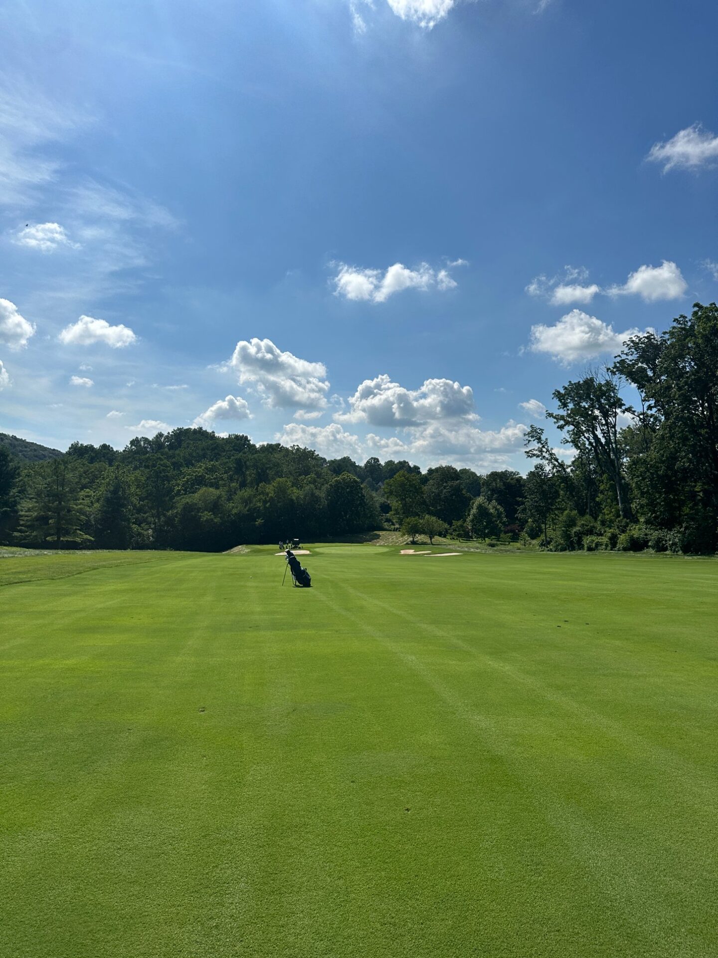 A stand bag alone on the fairway at Stonewall, the course stretching ahead