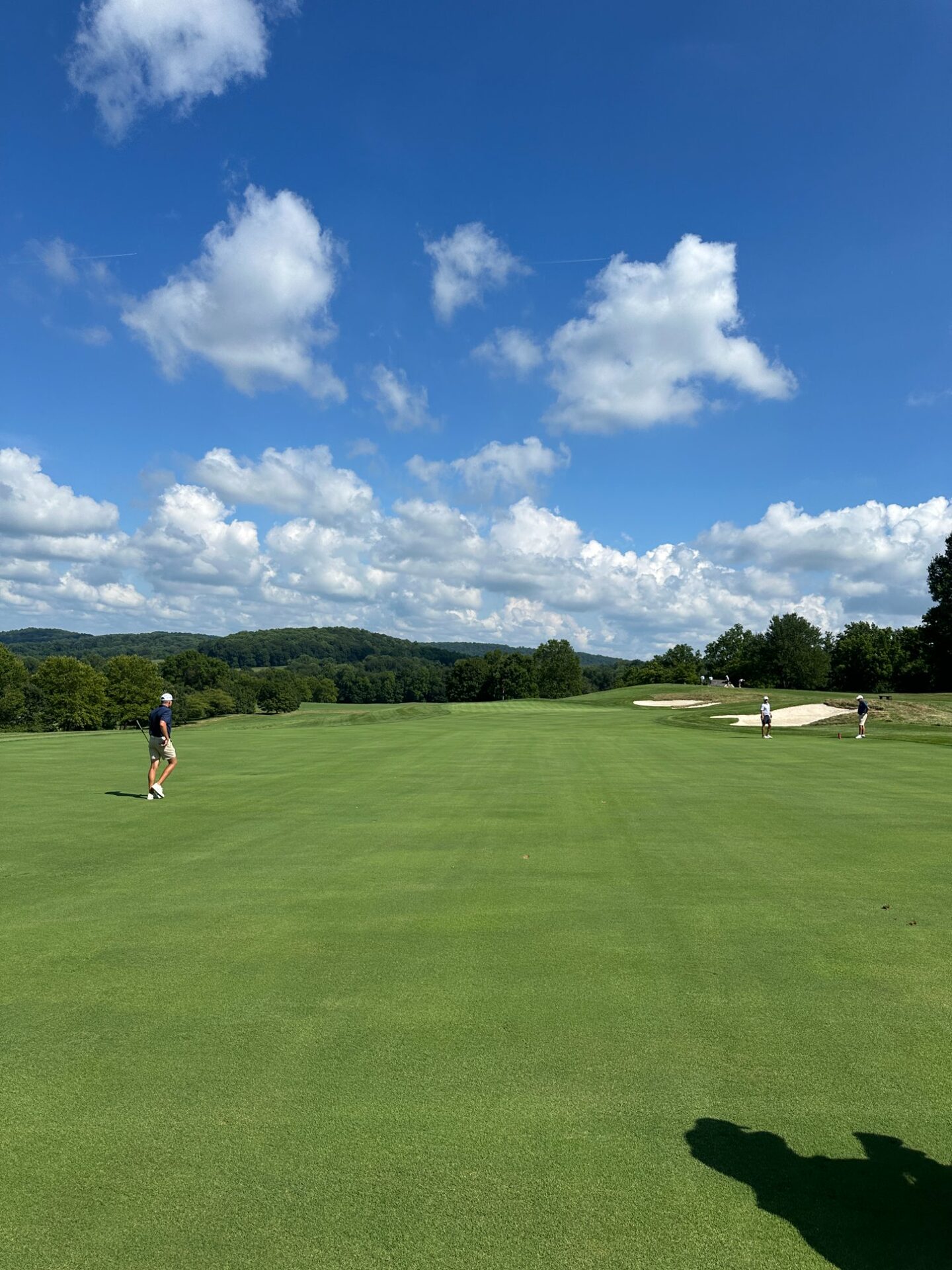 Players approaching the green at Stonewall with bunkers and rolling hills